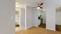 Located at 7402 Heritage Hills Dr in Tampa, FL, this single-floor residence offers a clean, functional layout with a comfortable and practical design throughout. The spacious living area is finished with warm carpeting and neutral-toned walls, creating a bright and welcoming atmosphere. A ceiling fan adds to the comfort of the space, while multiple windows dressed with blinds and vertical shades allow for generous natural light. A sliding glass door provides additional brightness and access to the outdoors. The galley-style kitchen is well-appointed with white cabinetry, granite countertops, stainless steel appliances including a refrigerator and range, and wood-look flooring that adds warmth and durability. Ample counter and cabinet space make the kitchen highly functional. The bathroom features a tub-shower combination with white tile surround, a white vanity with granite countertops, brushed nickel fixtures, and wood-look flooring that ties the space together cohesively. The bedroom is generously sized with soft carpeting and neutral walls, offering a quiet and restful retreat. Overall, the unit presents a clean, move-in-ready aesthetic with consistent finishes throughout.