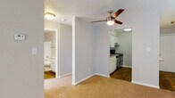 Located at 7402 Heritage Hills Dr in Tampa, FL, this single-floor residence offers a clean, functional layout with a comfortable and practical design throughout. The spacious living area is finished with warm carpeting and neutral-toned walls, creating a bright and welcoming atmosphere. A ceiling fan adds to the comfort of the space, while multiple windows dressed with blinds and vertical shades allow for generous natural light. A sliding glass door provides additional brightness and access to the outdoors. The galley-style kitchen is well-appointed with white cabinetry, granite countertops, stainless steel appliances including a refrigerator and range, and wood-look flooring that adds warmth and durability. Ample counter and cabinet space make the kitchen highly functional. The bathroom features a tub-shower combination with white tile surround, a white vanity with granite countertops, brushed nickel fixtures, and wood-look flooring that ties the space together cohesively. The bedroom is generously sized with soft carpeting and neutral walls, offering a quiet and restful retreat. Overall, the unit presents a clean, move-in-ready aesthetic with consistent finishes throughout.