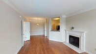 Located at 3301 Cotton Mill Dr in Raleigh, NC, this single-floor residence offers a well-designed layout that balances comfort and functionality. The main living area is bright and open, featuring warm hardwood-style flooring, neutral wall tones, and a classic fireplace with a white surround and marble-style hearth, serving as a natural focal point. Crown molding and clean white baseboards add architectural detail throughout the space.

The living area flows seamlessly into a dedicated dining space, illuminated by a pendant light fixture and defined by a tray ceiling. A pass-through window connects the dining area to the kitchen, enhancing the open feel. The kitchen is equipped with white shaker-style cabinetry, dark granite countertops, a gray subway tile backsplash, and stainless steel appliances, including a range, microwave, and dishwasher.

A separate room features large windows and a glass door opening to an outdoor balcony, allowing for generous natural light and outdoor views. The bathroom showcases a wide white vanity with ample counter space, a full-width mirror, and modern lighting. The floorplan, as visible in the dollhouse view, includes multiple rooms with a logical and efficient flow throughout the single-level layout.