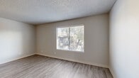 Located at 5555 E 14th St in Tucson, Arizona, this well-appointed 2-bedroom, 1-bathroom residence offers a thoughtfully organized single-floor layout with clean, updated finishes throughout. The two living areas feature light-toned wood-look flooring, neutral walls, textured ceilings, and windows with blinds that let in natural light and offer views of surrounding trees and outdoor spaces. A ceiling fan in one of the living areas adds comfort and function.

The galley-style kitchen is a standout feature, equipped with stainless steel appliances including a gas range, refrigerator, and dishwasher. White cabinetry with modern hardware, a stainless steel sink, white countertops, and a gray subway tile backsplash give the kitchen a crisp, contemporary feel.

Both bedrooms are carpeted and bright, each with windows that bring in natural light. The primary bedroom includes a built-in closet with sliding doors and direct access to the bathroom. The bathroom offers a white vanity with ample counter space, a mirror, and convenient access to an additional shelved closet for extra storage.

Clean lines, neutral tones, and updated materials throughout create a cohesive and comfortable living environment well-suited for everyday life in Tucson.
