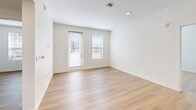 Located at 572 Gibson Dr in Roseville, CA, this 2-bedroom, 2-bathroom unit offers a thoughtfully designed single-floor layout with a clean, contemporary aesthetic throughout. Light wood-tone flooring runs consistently across the entire unit, contributing to a cohesive and bright interior.

The kitchen is a standout feature, showcasing modern two-tone cabinetry combining matte gray lower cabinets with warm wood-finish uppers. White quartz countertops, a glossy subway tile backsplash, and stainless steel appliances—including a refrigerator, range, and built-in microwave—complete the functional and stylish space. Recessed lighting illuminates the open kitchen and adjoining living area.

The bedrooms are bright and simply finished, with white walls and windows fitted with horizontal blinds that allow natural light. The primary bedroom offers a comfortable footprint, while the second bedroom provides a versatile space suitable for various uses.

Both bathrooms follow a consistent design, each featuring a tub-shower combination with white subway tile surround, wood-finish vanity cabinetry, white countertops, and wood-tone flooring. Two hallways connect the rooms efficiently, enhancing the flow of the overall layout.