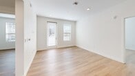 Located at 572 Gibson Dr in Roseville, CA, this 2-bedroom, 2-bathroom unit offers a thoughtfully designed single-floor layout with a clean, contemporary aesthetic throughout. Light wood-tone flooring runs consistently across the entire unit, contributing to a cohesive and bright interior.

The kitchen is a standout feature, showcasing modern two-tone cabinetry combining matte gray lower cabinets with warm wood-finish uppers. White quartz countertops, a glossy subway tile backsplash, and stainless steel appliances—including a refrigerator, range, and built-in microwave—complete the functional and stylish space. Recessed lighting illuminates the open kitchen and adjoining living area.

The bedrooms are bright and simply finished, with white walls and windows fitted with horizontal blinds that allow natural light. The primary bedroom offers a comfortable footprint, while the second bedroom provides a versatile space suitable for various uses.

Both bathrooms follow a consistent design, each featuring a tub-shower combination with white subway tile surround, wood-finish vanity cabinetry, white countertops, and wood-tone flooring. Two hallways connect the rooms efficiently, enhancing the flow of the overall layout.