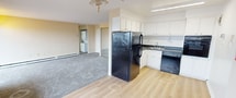 This 640 square foot apartment in Philadelphia offers a functional layout with two bedrooms, one bathroom, and a living room. The primary bedroom, measuring 190 square feet, provides ample space for comfort. The apartment features large windows that flood the rooms with natural light, offering scenic city views. A standout feature is the balcony, accessible through sliding glass doors, perfect for enjoying outdoor space.

The living areas are finished with neutral-toned walls and carpeting, creating a blank canvas for personalization. The kitchen, while compact, includes essential appliances and connects openly to the living space. The bathroom is efficiently designed with white tiling and a mirrored cabinet for storage.

Climate control is provided by a combination of air conditioning units and baseboard heating. A ceiling fan in the main living area aids in air circulation. The apartment's single-floor design ensures easy accessibility throughout the space. With its efficient use of space and modern amenities, this apartment offers comfortable urban living in a prime Philadelphia location.