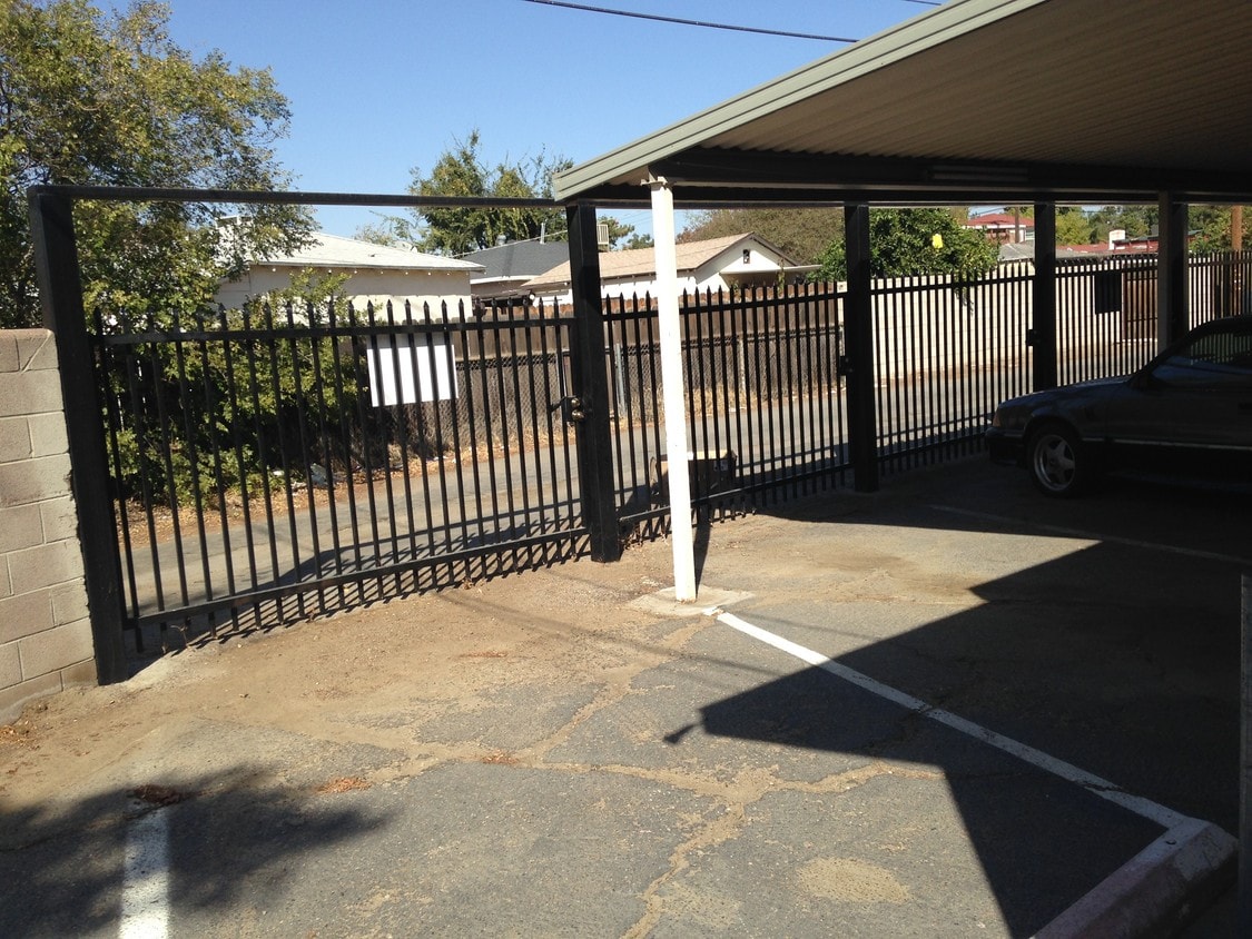 Recently installed wrought iron enclosure for covered parking spaces. - 250 Goodman St