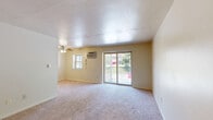 Located at 124 Toll House Road in Greensburg, PA, this one-bedroom, one-bathroom residence offers a practical and comfortable layout across a single floor. The living room is a bright, open space featuring soft carpeting, a ceiling fan, and a wall-mounted air conditioning unit. A sliding glass door leads directly to a private balcony, filling the room with natural light and providing a pleasant outdoor view of surrounding greenery. The kitchen is efficiently designed with warm wood-toned cabinetry, granite-style countertops, a double-basin sink, and a dishwasher, with an opening that connects visually to the living area. The bedroom is a generously sized, carpeted room bathed in natural light from a large window overlooking trees. It features multiple closets with louvered bi-fold doors, offering exceptional storage capacity. Additional closets are found throughout the unit, providing even more organizational flexibility. The bathroom is finished with classic white wall tiling, a full soaking tub with shower, wood-look flooring, and a vanity with storage. A dedicated entrance and hallway complete the layout, creating a logical and easy flow throughout the home.