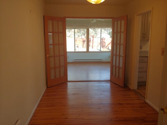 Dining room and doors opening to the sunroom. - 7415 1st Ave S