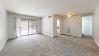 Located at 1925 Lawrence Rd in Havertown, PA, this well-laid-out two-bedroom, one-bathroom unit offers a comfortable and functional single-floor living experience. The open living and dining area is generously sized, featuring plush wall-to-wall carpeting, a ceiling fan with light fixture, and a sliding glass door that opens to a private balcony, filling the space with natural light and outdoor views. A wall-mounted heating unit provides efficient climate control. The layout flows seamlessly into the kitchen, which is outfitted with white cabinetry, dark granite-style countertops, a gas range, and warm hardwood flooring — all brightened by a window with blinds. Both bedrooms are carpeted and comfortably proportioned. The spacious primary bedroom features a ceiling fan with lighting and a closet with louvered doors. The second bedroom offers a window and ceiling-mounted light fixture. The unit includes four closets in total, providing ample storage throughout. The full bathroom features a tiled tub/shower combo and stone-look tile flooring. A connecting hallway ties all rooms together efficiently. The overall aesthetic is clean, neutral, and move-in ready.