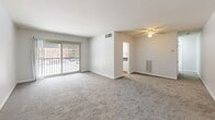 Located at 1925 Lawrence Rd in Havertown, PA, this well-laid-out two-bedroom, one-bathroom unit offers a comfortable and functional single-floor living experience. The open living and dining area is generously sized, featuring plush wall-to-wall carpeting, a ceiling fan with light fixture, and a sliding glass door that opens to a private balcony, filling the space with natural light and outdoor views. A wall-mounted heating unit provides efficient climate control. The layout flows seamlessly into the kitchen, which is outfitted with white cabinetry, dark granite-style countertops, a gas range, and warm hardwood flooring — all brightened by a window with blinds. Both bedrooms are carpeted and comfortably proportioned. The spacious primary bedroom features a ceiling fan with lighting and a closet with louvered doors. The second bedroom offers a window and ceiling-mounted light fixture. The unit includes four closets in total, providing ample storage throughout. The full bathroom features a tiled tub/shower combo and stone-look tile flooring. A connecting hallway ties all rooms together efficiently. The overall aesthetic is clean, neutral, and move-in ready.