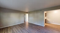Located at 600 Bartlett St in Huntington, Indiana, this single-floor, 2-bedroom, 1-bathroom unit offers a well-planned layout with a clean, neutral aesthetic throughout. The living room features durable hardwood-style flooring, soft neutral-toned walls, and a textured ceiling, creating a bright and welcoming atmosphere with easy flow into adjacent areas. The kitchen is well-appointed with dark wood cabinetry, light quartz countertops, hardwood-style flooring, and stainless steel appliances including a refrigerator, range, and microwave — providing both style and functionality in a compact, efficient space. Both bedrooms are carpeted for comfort and are filled with natural light from large windows that frame views of surrounding mature trees. The primary bedroom offers a generous footprint with a spacious closet, while the second bedroom also includes a closet and comparable natural light. The bathroom is neatly finished with a combined tub and shower, a single-sink vanity with dark wood cabinetry, and coordinating hardwood-style flooring. Throughout the unit, consistent neutral tones and practical finishes contribute to a cohesive, move-in-ready living environment.