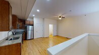 Located at 2240 Rivermont Ave in Lynchburg, Virginia, this two-floor residence offers a practical and well-maintained living environment with a clean, neutral aesthetic throughout. The main living area is open and airy, featuring light hardwood flooring, recessed lighting, and ceiling fans that contribute to a comfortable atmosphere. A window allows natural light to filter into the space, enhancing the bright, welcoming feel of the main floor.

The kitchen is a functional highlight, equipped with rich, warm-toned wood cabinetry, granite-style countertops, and a full suite of stainless steel appliances — including a refrigerator, range, microwave, and dishwasher. The kitchen opens toward the living area, creating a connected, easy-to-navigate layout. A peninsula-style counter serves as a natural divider between the kitchen and living space.

The bathrooms are clean and straightforward in design. A full bathroom features light tile flooring, a white vanity with ample cabinet storage, and a tub-shower combination. An additional water closet provides added convenience. Throughout the residence, six-panel interior doors and consistent trim details lend a cohesive, tidy appearance. The two-floor layout offers separation between living and private spaces, making this a well-organized and functional home.
