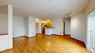 Located at 400 Wall St in Seattle, WA, this one-bedroom, one-bathroom residence offers a well-designed layout across a single floor. The open-concept living, dining, and kitchen area serves as the heart of the unit, featuring warm hardwood flooring that flows throughout the main living spaces. Large sliding glass doors lead to a private balcony, allowing natural light to fill the room alongside an additional picture window framing views of the surrounding neighborhood.

The kitchen is equipped with stainless steel appliances, including a refrigerator, microwave, and dishwasher, complemented by warm wood cabinetry and granite countertops that extend to a breakfast bar peninsula — ideal for casual dining. A dedicated den provides flexible space for a home office or additional living area.

The bedroom is carpeted for comfort and includes access to a generously sized walk-in closet with wire shelving for ample storage, plus an additional closet. The full bathroom features tile flooring, a granite-topped wood vanity, and a soaking tub. Completing the layout is an in-unit laundry area, adding everyday convenience to this thoughtfully appointed Seattle residence.