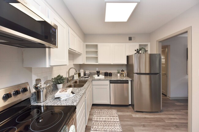 Kitchen with granite counters, stainless appliances, and modern cabinetry - Edison at Meridian Hills