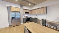 This contemporary 1140 square foot apartment, located in the heart of downtown, offers a perfect blend of urban living and modern comfort. The open-concept design seamlessly integrates the kitchen, living, and dining areas, creating a spacious and inviting atmosphere. The kitchen is a chef's dream, featuring sleek cabinetry in a two-tone design of light wood and dark gray, complemented by stainless steel appliances and ample counter space.

Both bathrooms exude elegance with their minimalist design, featuring floating vanities, large mirrors, and glass-enclosed showers. The primary bedroom, spanning 190 square feet, provides a generous retreat with large windows that flood the space with natural light. Built-in storage solutions and hardwood flooring throughout add both functionality and warmth to the living spaces.

A standout feature is the private balcony, accessible from both the living area and bedroom, offering stunning views of the surrounding cityscape. The apartment's industrial-chic aesthetic is emphasized by exposed concrete ceilings, creating a unique visual interest that contrasts beautifully with the otherwise polished interiors.

Located in a stylish complex with distinctive architecture, this apartment combines the excitement of downtown living with the comfort and amenities of a modern home. Its thoughtful layout and high-end finishes make it an ideal urban oasis for those seeking a sophisticated lifestyle in the heart of the city.