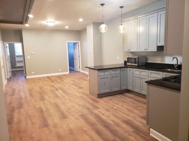 Open concept apartment with large living room, dining, and kitchen - 2892 S Archer Ave