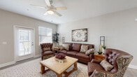 Located at 5353 N US Highway 27 in Ocala, FL, this well-appointed 2-bedroom, 2-bathroom single-story home offers a thoughtfully designed layout across a comfortable footprint. The open-concept living room welcomes you with vaulted ceilings, a ceiling fan, and large windows that flood the space with natural light. Light-toned walls and wood-look flooring run throughout, creating a cohesive and inviting atmosphere.

The kitchen is a standout feature, showcasing white shaker-style cabinetry extending to the ceiling, granite countertops, stainless steel appliances, and a central island — ideal for both cooking and entertaining. A stylish barn door accent is visible from the connecting hallway, which leads to the dining and main living areas.

The primary bedroom offers a generous layout with a ceiling fan, large windows, and direct access to a private bathroom featuring a tub-shower combo. Three closets throughout the home provide excellent storage, including spacious walk-in wire-shelving systems. The laundry room is fully functional with additional built-in shelving and a water heater housed within.

A patio extends the living space outdoors, and two hallways connect the home's rooms with ease. This single-floor residence combines practical design with comfortable Florida living.