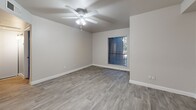 Located at 3434 E McDowell Rd in Phoenix, AZ, this 2-bedroom, 1-bathroom unit offers a thoughtfully designed single-floor layout with modern finishes throughout. The open living area features light wood-style flooring, neutral gray walls, and a ceiling fan with integrated lighting, creating a clean and airy atmosphere. The space flows seamlessly into the kitchen, which is equipped with stainless steel appliances including a refrigerator, range, and microwave, complemented by white cabinetry, light countertops, and recessed lighting. Both bedrooms feature wood-style flooring in a cool gray tone and vertical blinds over windows that let in natural light. The primary bedroom includes a ceiling fan and a window with outdoor views, while the second bedroom offers a quiet, versatile layout. The bathroom features a white vanity with a light countertop and a mirrored medicine cabinet, connected to the rest of the unit via a clean, well-lit hallway. Consistent use of neutral tones, white trim, and updated flooring throughout gives the entire unit a cohesive, contemporary feel well-suited for everyday living in Phoenix.
