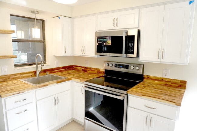 Remodeled kitchen with white cabinets, wood tops, new appliances for Nature Coast cooking. - 33 63rd St