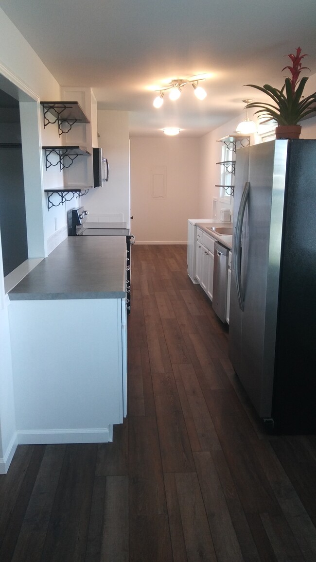 Kitchen with view of mud room and laundry hook ups - 26987 Henderson Rd