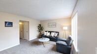 Located at 6741 C Avenue NE in Cedar Rapids, Iowa, this one-bedroom, one-bathroom single-floor unit offers a thoughtfully arranged layout that maximizes functionality across seven distinct rooms. The carpeted living room serves as the heart of the home, bathed in natural light through vertical-blind windows and finished with a textured ceiling that adds subtle character. Adjacent to the living area, the dining room features a ceiling fan, chair-rail wainscoting, and a window overlooking the exterior, creating a bright and defined dining space. The galley-style kitchen is efficiently designed with wood-trimmed cabinetry, white countertops, hardwood-style flooring, and a full suite of appliances including a refrigerator, range, and dishwasher. The dedicated office provides a quiet, carpeted retreat with a window framing outdoor greenery. The primary bedroom is a comfortable, well-proportioned room with plush carpeting, a ceiling fan with light fixture, and a window for natural light. The bathroom includes a vanity with ample counter space, a shower/tub combination, and hardwood-style flooring. A carpeted hallway connects the rooms, completing this practical and inviting single-level home.