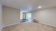 Located at 15940 Bayberry Ln in San Lorenzo, CA, this one-bedroom, one-bathroom unit offers a well-organized single-floor layout designed for comfortable everyday living. The open living area is finished with warm hardwood-style flooring and neutral cream-toned walls that create a clean, inviting atmosphere. A ceiling fan with light fixture anchors the space, while a sliding glass door floods the room with natural light and provides direct access to an outdoor patio with lush greenery views. A second window further enhances the bright, airy feel of the living area.

The galley-style kitchen runs along a narrow corridor and features white cabinetry on both sides, brown stone-look countertops, a double sink, and white appliances including a refrigerator, electric range, and microwave. Hardwood-style flooring continues throughout, keeping the space cohesive and easy to maintain.

The bedroom is carpeted for comfort and receives natural light through a window with outdoor views. It offers a well-proportioned layout with access to a hallway and a dedicated closet for storage. The bathroom is neatly finished with a white vanity, mirrored medicine cabinet, and a tub/shower combo enclosed by sliding glass doors, all set over hardwood-style flooring for a clean, cohesive look.
