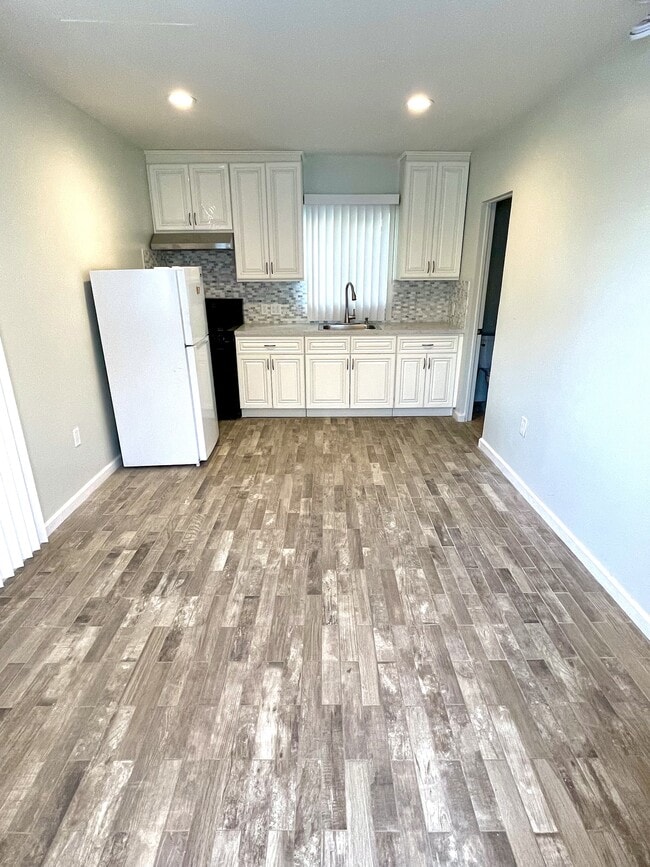 living space and newly renovated full kitchen area with recessed LED lighting - 7951 Clearfield Ave