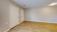 Located at 1004 Appamattox Ct in Fayetteville, NC, this single-floor unit offers a thoughtfully laid-out interior with modern finishes and a clean, neutral aesthetic. The open-concept living and kitchen area serves as the heart of the home, featuring light wood-style flooring that extends seamlessly throughout the common spaces. The kitchen is equipped with stainless steel appliances, including a refrigerator and range, white cabinetry with a classic subway tile backsplash, and a peninsula with a built-in sink and light countertops that doubles as a casual dining or prep area. A large window in the living area allows natural light to pour in, creating a bright and welcoming atmosphere. The bedroom offers plush carpeting for comfort and includes multiple closets for ample storage, along with a window that provides natural light and outdoor views. A hallway connects the main living spaces, with additional storage accessible along the way. Textured ceilings and flush-mount lighting fixtures are consistent throughout the unit. The overall ambiance is clean, functional, and move-in ready, making it a practical and comfortable living space.