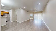 Located on East Camelback Road in Phoenix, Arizona, this one-bedroom, one-bathroom residence offers a well-designed single-floor layout with a bright and airy atmosphere throughout. The open-concept living and kitchen area forms the heart of the home, featuring light-toned luxury vinyl plank flooring, recessed lighting, and a ceiling fan that enhances airflow in the Arizona climate. A full-length vertical blind–covered sliding glass door floods the space with natural light and provides outdoor access. The kitchen is equipped with warm-toned wood cabinetry, stainless steel appliances including a refrigerator, electric range, and built-in microwave, complemented by a tile backsplash and light countertops. A dedicated laundry area houses a full-sized washer and dryer. The generously sized bedroom features plush carpet, a ceiling fan, a wide window with blinds, and a sliding glass door, creating a comfortable and well-lit retreat. The bathroom includes a shower-tub combo, a wood-vanity with a light countertop, and tile-style flooring. Neutral, warm-beige tones and clean white trim carry consistently throughout the residence, creating a cohesive and move-in-ready environment well-suited to the vibrant Camelback corridor.
