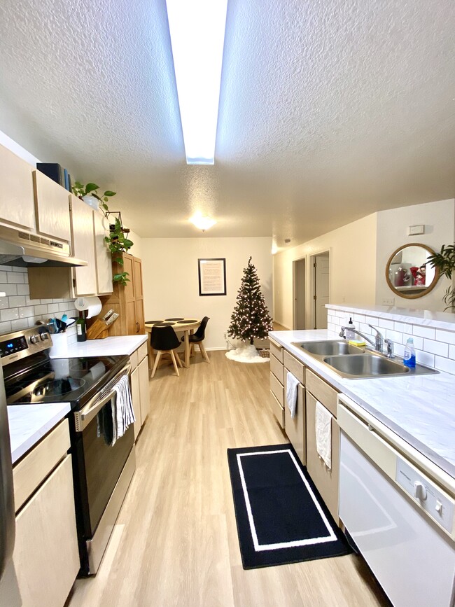 Kitchen with new luxury vinyl plank flooring, new stainless steel sink and faucet. - 135 Baker Street #102