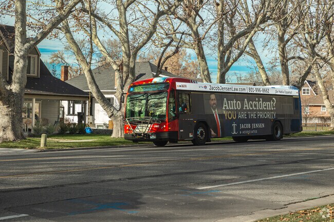 A bus stops in front of homes in a tree lined street in Farmington.