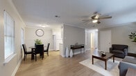 Located at 426 Mesa Ct in Little Rock, Arkansas, this two-bedroom, one-bathroom home offers a thoughtfully arranged single-floor layout. Light wood-style flooring flows throughout the space, complemented by neutral wall tones, crown molding, and ceiling fans that contribute to a clean, cohesive aesthetic.

The open-concept living and dining area forms the heart of the home. The living room provides a comfortable gathering space with crown molding trim, while the adjacent dining area benefits from multiple windows fitted with horizontal blinds, allowing ample natural light to fill the room. The galley-style kitchen is outfitted with white cabinetry, granite-style countertops, a mosaic tile backsplash, and white appliances, offering a functional and tidy cooking space.

A hallway leads to the two bedrooms, each featuring ceiling fans with light fixtures and windows that bring in natural light. The primary bedroom is generously proportioned and includes a closet, while the second bedroom offers similar comfort and access to storage. The shared bathroom features white cabinetry with granite-style countertops, a tub/shower combination, and wood-style flooring consistent with the rest of the home. Together, these spaces deliver a practical and welcoming residence in Little Rock.