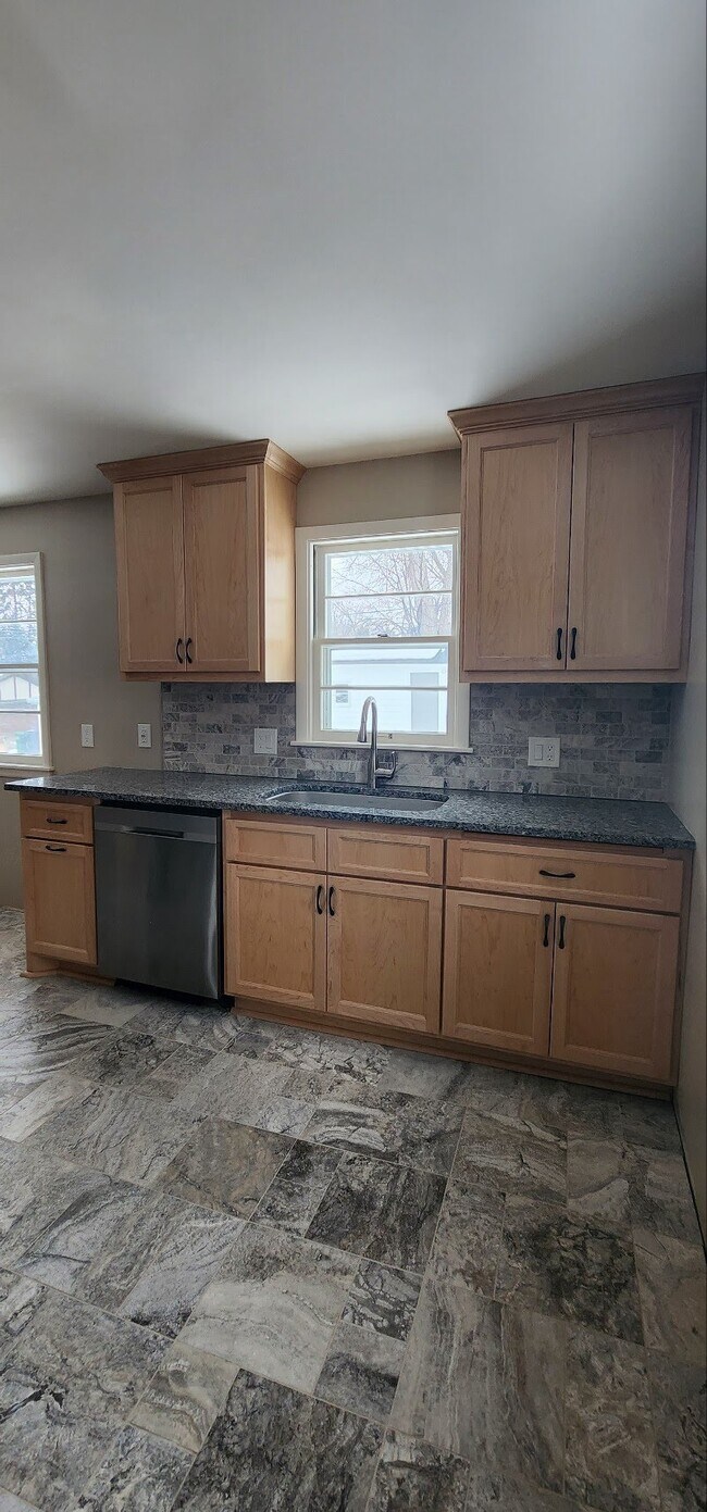 Maple and Travertine Kitchen Elegance - 3219 Taylor St NE