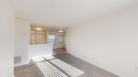 Located at 1307 Tittabawassee Rd in Saginaw, Michigan, this single-floor, 2-bedroom, 2-bathroom home offers a functional and comfortable layout. The combined kitchen and living room serves as the heart of the home, where light wood-look flooring flows through the kitchen area while plush carpeting defines the living space. The kitchen is equipped with ample wood-trimmed white cabinetry, a double sink, a full suite of white appliances including a range, dishwasher, and refrigerator, and a practical peninsula that provides separation from the living area. Natural light pours in through multiple windows, brightening the open layout throughout the day. The primary bedroom is a well-proportioned retreat featuring soft carpet, a large window with vertical blinds, and access to a dedicated closet with built-in rods for organized storage. The second bedroom is equally comfortable with carpeted floors and good natural light. Both bathrooms are clean and functional, featuring light wood-look flooring, a vanity with white countertops and wood-accented cabinetry, and a tub-shower combination. A hallway connects the private areas of the home, and a dedicated closet provides additional storage. The overall aesthetic is clean, bright, and move-in ready.