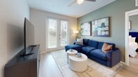 Located in Tampa, FL, this thoughtfully designed 2-bedroom, 2-bathroom residence offers a modern aesthetic across a single, efficiently laid-out floor. The open-concept kitchen and living area serves as the heart of the home, featuring white shaker cabinetry, quartz countertops, stainless steel appliances, and a peninsula island with bar seating — all illuminated by sleek pendant lighting. Light wood-style flooring flows throughout, enhancing the bright, airy atmosphere. The living room offers access to the outdoors through full-length glass doors, filling the space with natural light and views of greenery. A ceiling fan adds comfort overhead.

The primary bedroom is a serene retreat with a sage green accent wall, ceiling fan, and direct access to a spacious walk-in closet fitted with wire shelving. Its en-suite bathroom features a frameless glass walk-in shower, a floating vanity with quartz countertops, and large-format tile flooring. The second bedroom features a bold navy accent wall, a bright window with palm tree views, and light wood flooring. The second bathroom offers a full tub-shower combination with clean white finishes. Two dedicated closets provide ample storage throughout the residence.