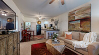 Located at 250 Bellerive Ave in Bryant, Arkansas, this 1-bedroom, 1-bathroom residence offers a thoughtfully designed single-floor layout that maximizes comfort and functionality. The open-concept living and kitchen area serves as the heart of the home, where the two spaces flow seamlessly together. The kitchen is well-appointed with white cabinetry featuring dark granite-style countertops, black appliances including a range, microwave, and refrigerator, a dishwasher, and a breakfast bar with barstool seating — ideal for casual dining. Wood-style flooring grounds the kitchen area, while ceiling fans in both the living room and kitchen area keep the space comfortable year-round. The living room is bright and inviting, with natural light streaming through large windows and a front entry door. Neutral carpet continues into the bedroom, which offers a generous layout, a ceiling fan, and a window with outdoor views. A dedicated closet provides practical storage. The bathroom features a single vanity with a framed mirror, overhead lighting, white cabinetry, and a shower-tub combination. Throughout the space, neutral wall tones and consistent finishes create a cohesive and welcoming atmosphere.
