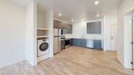 Located at 1724 N Union Rd in Spokane Valley, WA, this one-bedroom, one-bathroom unit offers a well-designed layout across a single floor. Light wood-look flooring runs throughout the space, complementing the clean, white walls and creating a bright, cohesive aesthetic.

The kitchen is a standout feature, equipped with a full suite of stainless steel appliances including a refrigerator, electric range, over-the-range microwave, and dishwasher. Two-tone cabinetry — dark wood upper cabinets paired with slate-blue lower cabinets — frames light quartz countertops, lending the kitchen a contemporary feel. Recessed lighting illuminates the space, and a dedicated in-unit washer alcove adds everyday convenience.

The bedroom offers a comfortable footprint with a double-door closet for ample storage. A window with horizontal blinds invites natural light and provides views of the surrounding greenery. A baseboard heater ensures year-round comfort.

The bathroom features a full tub/shower combination with built-in shelving, brushed nickel fixtures, and wood-look tile flooring that ties in with the rest of the unit.

A private balcony extends the living space outdoors, overlooking manicured landscaping and the neighborhood beyond — a pleasant spot to enjoy the Pacific Northwest scenery.