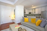 Located at 145 Granby Street in Norfolk, Virginia, this single-floor residence offers a cohesive and well-designed living environment with modern finishes throughout. Rich hardwood flooring flows continuously through the main living areas and bedrooms, adding warmth and visual continuity to the space.

The kitchen is outfitted with crisp white shaker-style cabinetry, light stone countertops, and a soft gray glass tile backsplash that adds a contemporary touch. Stainless steel appliances, including a range, built-in microwave, and dishwasher, complete the functional and stylish cooking space.

The living area is bright and inviting, featuring neutral walls, dual windows that draw in natural light, and a ceiling fan overhead. The open layout creates a comfortable setting suitable for both relaxing and entertaining.

The primary bedroom features rich hardwood flooring, a ceiling fan, a built-in closet, and direct access to an adjacent room, providing a private and restful retreat. A secondary bedroom offers a cozy and efficient layout with its own closet and patterned carpet flooring.

The bathroom is clean and well-appointed, with large-format light tile flooring, a dark espresso vanity with an integrated mirror, wall-mounted cabinetry, and a shower-tub combination, all illuminated by a bright window that enhances the airy atmosphere.