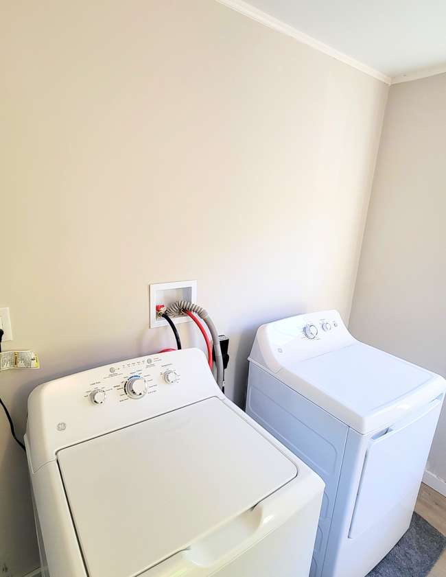 The laundry room comes with a new washer and dryer. There is also a closet for linens. - 20 Kenyon Rd