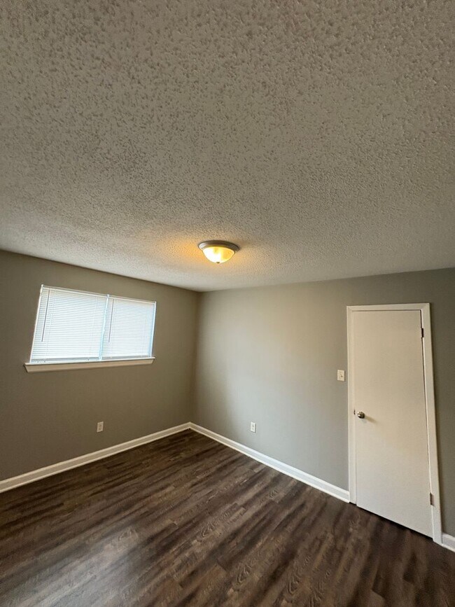 Photo - This 2BR/1BA includes a nice-sized living area, an ample kitchen, a fenced-in Townhome