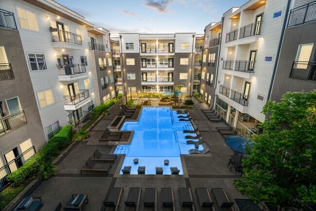 Resort-style pool area complete with sun shelf, lounge seating and fire feature - Larq Henderson
