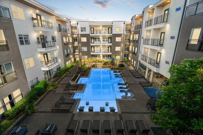 Resort-style pool area complete with sun shelf, lounge seating and fire feature - Larq Henderson