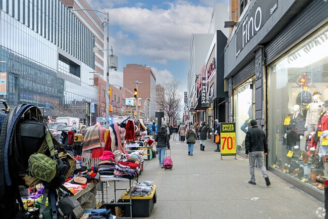 Stores and vendors line streets in Harlem.