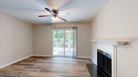 Located in Chesterfield, MO, this 2-bedroom, 1-bathroom home offers a thoughtfully arranged single-floor layout. The living area serves as the heart of the home, highlighted by durable wood-style flooring, a classic fireplace with a white mantle, and a ceiling fan with integrated lighting. A sliding glass door floods the space with natural light and opens to a private balcony overlooking lush greenery, creating a seamless indoor-outdoor connection. The textured ceiling adds a traditional touch throughout the main living areas. The galley-style kitchen is efficiently designed with rich wood cabinetry, dark granite-style countertops, and a full suite of appliances including a refrigerator, range, and built-in microwave. A window above the sink brings in additional natural light and garden views. Both bedrooms are carpeted for comfort and feature neutral walls, natural light from windows with outdoor views, and textured ceilings. The primary bedroom offers a generous footprint with ample space for furnishings. The bathroom is cleanly appointed with a wood-toned vanity, granite-style countertop, and a full tub-shower combination. A hallway connects the private areas of the home, completing this practical and comfortable layout.