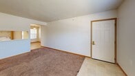 Located at 1336 Birch Tree Ln in Traverse City, Michigan, this two-bedroom, two-bathroom single-floor unit offers a functional and well-organized layout across a comfortable footprint. The living room serves as the central gathering space, featuring plush carpeting, a textured ceiling, and a large window that fills the room with natural light and provides outdoor views. Tile flooring at the entryway transitions seamlessly into the carpeted living area.

The kitchen is equipped with warm wood-toned cabinetry, a white electric range, refrigerator, and a built-in range hood. A convenient in-unit laundry closet is located just off the kitchen, housing a full-sized washer and dryer. Light tile flooring runs throughout the kitchen and both bathrooms.

Both bedrooms are carpeted and feature large windows — one overlooking a wooded backdrop and the other with views of the surrounding neighborhood. The primary bedroom includes two closets with bi-fold doors and direct access to one of the full bathrooms. Each bathroom is fitted with a wood-toned vanity, tile flooring, a tub-shower combination, and a mirrored vanity light above the sink. A hallway connects the main areas of the unit, completing this practical and comfortable layout.