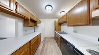 Located at 220 W Valley Rd in Appleton, Wisconsin, this one-bedroom, one-bathroom residence offers a thoughtfully organized single-floor layout with a clean, functional design throughout. The galley-style kitchen is lined with warm oak cabinetry on both sides, providing generous storage and counter space. It is equipped with a range, dishwasher, and refrigerator, and features light wood-look flooring that carries a bright, tidy aesthetic. The kitchen flows naturally toward a combined dining and living area, which is spacious and open, enhanced by a ceiling fan, baseboard heating, and a sliding glass door that fills the room with natural light and leads to a private balcony. The bedroom is a comfortable size, finished with plush carpeting, a window with an outdoor view, and access to two closets, offering ample storage. The full bathroom includes a tub/shower combination, a vanity with oak cabinetry, and wood-look flooring, maintaining a consistent and clean design. An in-unit laundry area adds everyday convenience. Neutral wall tones and warm wood trim details throughout create a welcoming, livable ambiance well-suited for comfortable everyday living in Appleton.
