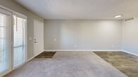 Located at 5755 E River Rd in Tucson, Arizona, this single-story residence offers a thoughtfully designed layout with one bedroom and two bathrooms. The open-concept living and dining area is finished with plush carpet and wood-look flooring at the entryway, with a textured ceiling and natural light streaming through sliding glass doors and windows. A pass-through window connects the living space to the galley-style kitchen, which is outfitted with white cabinetry, quartz countertops, stainless steel appliances including a refrigerator, range, microwave, and dishwasher, and wood-look tile flooring. The bedroom is a comfortable, carpeted retreat featuring dual sliding-door closets, a ceiling fan with light fixture, and a window with blinds that allows for natural light. The bathrooms are clean and functional, with one featuring a full soaking tub and shower combination with bright white surround, and the other showcasing wood-look flooring, a vanity with mirror, and modern wall lighting. Neutral tones and clean white trim are carried throughout, creating a cohesive and move-in ready atmosphere suited for comfortable Tucson living.