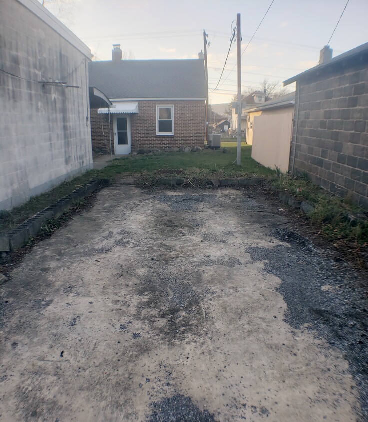 Off Street parking space (Behind House) w/ motion sensor lights (pointing towards parking/path and on the back door) - 3633 N 6th St