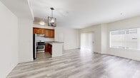 Located in the heart of Los Angeles on Lanewood Avenue, this 2-bedroom, 2-bathroom residence offers a well-designed layout with thoughtful finishes throughout. Light wood-style flooring runs seamlessly across the entire home, creating a bright and cohesive aesthetic.

The open-concept kitchen and living area form the heart of the home. The kitchen is well-appointed with warm-toned wood cabinetry, granite countertops, stainless steel appliances including a gas range and refrigerator, and a peninsula that transitions naturally into the spacious living area. A stylish pendant chandelier anchors the kitchen, adding a decorative touch. The living room is bathed in natural light from large windows and a sliding glass door, creating an airy, welcoming atmosphere.

Both bedrooms are comfortably sized with clean white walls and natural light from well-positioned windows. The primary bedroom connects to a dedicated closet, while the second bedroom features mirrored sliding closet doors with built-in shelving, maximizing storage.

Both bathrooms mirror each other in design, each featuring marble-style tiled tub-shower combinations, granite-topped wood vanities, and light wood-style flooring — offering a clean, consistent finish. The overall ambiance of this residence is bright, modern, and move-in ready.