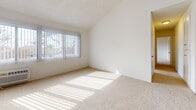 Located at 315 N Associated Rd in Brea, CA, this single-floor, 2-bedroom, 2-bathroom home offers a practical and comfortable layout. The combined living and dining area serves as the heart of the home, featuring hardwood-style flooring, a ceiling fan, vaulted ceiling detail, and a front entry door with vertical panel accents. Natural light filters through large windows with vertical blinds, brightening the open common areas. The galley-style kitchen is efficiently designed with white cabinetry, light stone-look countertops, a stainless steel sink, a white electric range, a dishwasher, and wood-style flooring, making the most of the available space. Both bedrooms are carpeted and well-lit with natural light. The spacious primary bedroom includes a generous walk-in closet outfitted with built-in shelving and hanging rods. The second bedroom also benefits from a closet and a large window overlooking the surroundings. Each bathroom is finished with wood-style flooring, a vanity with granite-look countertops, and white cabinetry. One bathroom features a walk-in shower, while the other offers a shower-tub combo. A connecting hallway ties all rooms together, creating a cohesive and functional flow throughout the home.