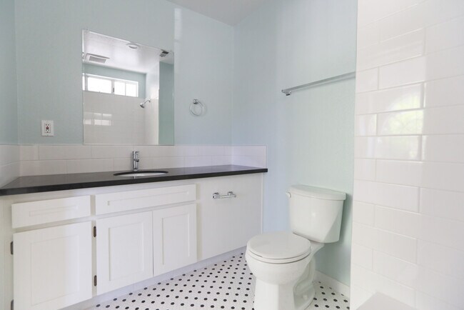 Master bathroom with full tub, new tile and granite counter tops - 122 West Main Avenue Apartments