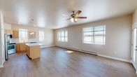 Located at 4615 Trellis Dr in De Pere, Wisconsin, this single-floor residence offers a thoughtfully designed layout with a cohesive blend of functionality and comfort. The open-concept living and kitchen area forms the heart of the space, bathed in natural light from multiple large windows that frame outdoor views of the surrounding neighborhood. Durable wood-look flooring extends throughout the main living areas, while a ceiling fan overhead adds both practicality and a finishing touch to the generous living room.

The kitchen is well-equipped with stainless steel appliances, including a refrigerator, range, and over-the-range microwave. Light wood cabinetry, stone-look countertops, and a classic subway tile backsplash lend the kitchen a clean, modern aesthetic. A central island provides additional prep and gathering space, seamlessly connecting the kitchen to the living area.

The bedrooms feature plush carpeting, ceiling fans, and wall-unit air conditioners, with baseboard heating ensuring year-round comfort. Each room benefits from natural light via well-positioned windows. The bathrooms are finished with wood-look flooring, light wood vanities, stone-look countertops, and a walk-in shower, offering a clean and practical design throughout.
